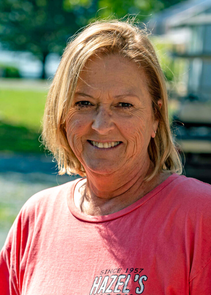 Sharon Collins has worked at the marina for decades, her sincere smile and Southern twang meeting every guest at the establishment's front desk. Credit: Lee Hedgepeth/Inside Climate News