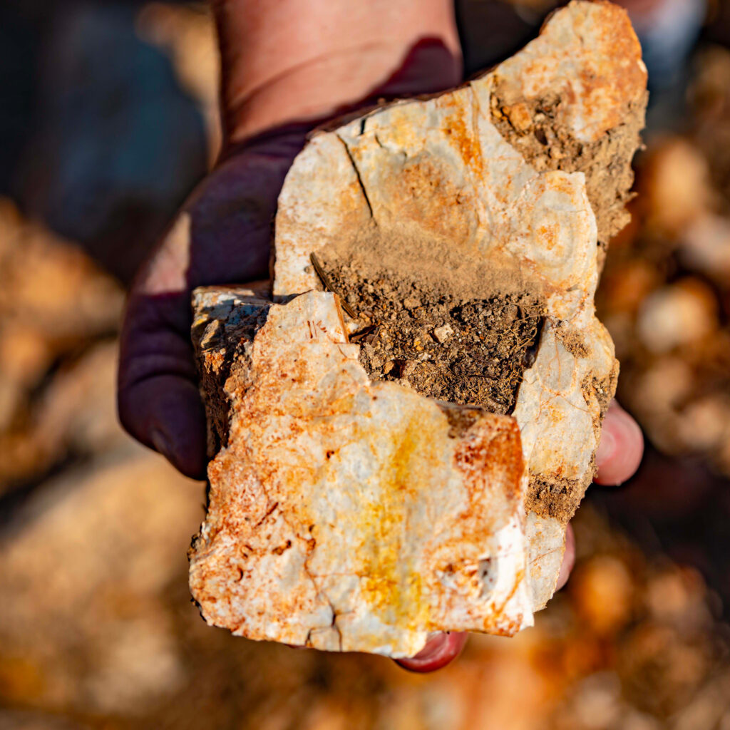 A resident holds North Alabama chert. Credit: Lee Hedgepeth/Inside Climate News