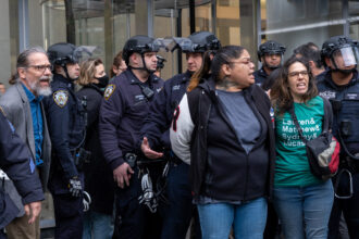 During a demonstration at Citibank’s headquarters in Manhattan on Wednesday, 33 protesters were taken into custody, including Rachel Rivera (center), a board member with New York Communities for Change. Credit: Keerti Gopal/Inside Climate News