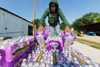 Milton Denney loads up bottled water for distribution to residents of Santee, Neb. High levels of manganese in the tribe’s water may have adverse effects on the central nervous systems of people who consume it. Credit: Jerry L Mennenga/Flatwater Free Press