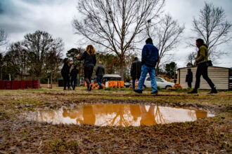 Shiloh, Alabama residents lead environmental scientist Robert Bullard’s rapid response team on a tour of their flooded community. Credit: Lee Hedgepeth/Inside Climate News