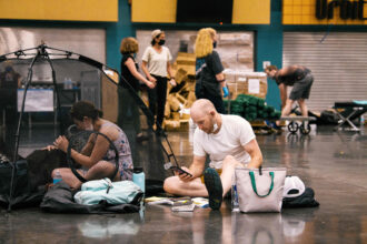 People and their pets rest at the Oregon Convention Center cooling station in Portland as the city is hit with extreme temperatures caused by a heat dome on June 28, 2021. Credit: Kathryn Elsesser/AFP via Getty Images