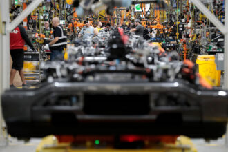 Production line workers assemble EV parts at the Ford Rouge Electric Vehicle Center in Dearborn, Michigan. Credit: Jeff Kowalsky/AFP via Getty Images