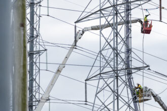 A crew works on transmission lines in Montgomery Village, Maryland. Maryland Gov. Wes Moore is among a group of governors calling on the regional grid operator to speed up transmission expansion. Credit: Eric Lee/The Washington Post via Getty Images