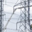 A crew works on transmission lines in Montgomery Village, Maryland. Maryland Gov. Wes Moore is among a group of governors calling on the regional grid operator to speed up transmission expansion. Credit: Eric Lee/The Washington Post via Getty Images