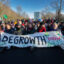 Demonstrators hold a sign reading Degrowth Now after they blocked the A12 highway during an Extinction Rebellion protest on March 11, 2023 in The Hague, Netherlands. Credit: Michel Porro/Getty Images