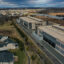 Amazon data centers are seen next to Loudoun Meadows houses in Aldie, Va. Credit: Jahi Chikwendiu/The Washington Post via Getty Images