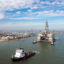 A tugboat tows a semi-submersible drilling platform into the Gulf of Mexico in Port Aransas, Texas. Credit: Tom Pennington/Getty Images