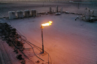 Natural gas is flared off during an oil-drilling operation in the Permian Basin in Stanton, Texas. A new study examined flaring and venting during oil and gas production. Credit: Joe Raedle/Getty Images