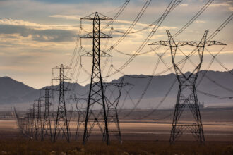 Heavy electrical transmission lines are located in California's Mojave Desert near the stateline community of Primm, Nevada. Credit: George Rose/Getty Images