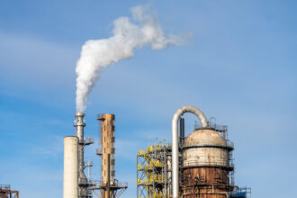 Steam rises from a petroleum processing tower at an oil refinery near Salt Lake City, Utah. Credit: Jon G. Fuller/VWPics/Universal Images Group via Getty Images