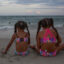 Children sit in the sand at Wrightsville Beach, North Carolina in the evening of July 23, 2023 to avoid the heat of the daytime. Credit: Madeline Gray for The Washington Post via Getty Images