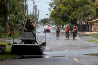 Rescue personnel walk through a flooded street after Hurricane Idalia passed offshore on Aug. 30, 2023 in Hudson, Fla. Credit: Joe Raedle/Getty Images