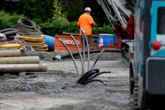 Construction of Eversource's geothermal pilot project takes place in the parking lot of Mass Bay Community College in Framingham, Mass. on Sept. 13, 2023. Credit: Jonathan Wiggs/The Boston Globe via Getty Images