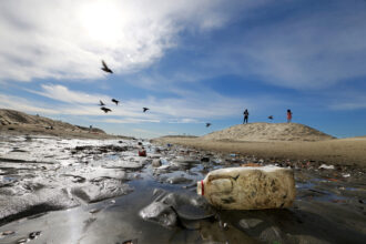 Plastic debris litters a drainage ditch to the sea at Junipero Beach in Long Beach, Calif. Credit: Luis Sinco/Los Angeles Times via Getty Images