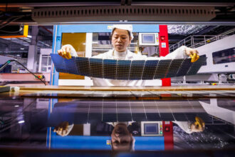 An employee produces photovoltaic panel components for export to the United States and Europe at a manufacturing plant in Suqian, China on Feb. 17. Credit: Costfoto/NurPhoto via Getty Images