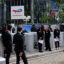 Shareholders enter the gates of the headquarters' of French oil and gas company TotalEnergies in Courbevoie, France on May 24. Credit: Stephane De Sakutin/AFP via Getty Images