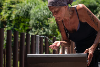 A woman gets water from a fountain in Manhattan as a heat wave blankets New York City on June 21. Credit: Spencer Platt/Getty Images