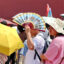 Tourists shield themselves from the sun while visiting the Palace Museum during a heat wave on July 6 in Beijing, China. Credit: VCG via Getty Images