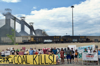 Curtis Bay residents joined activists and environmental advocates to protest fugitive coal dust escaping open-air coal pits, and asked the Maryland Department of the Environment to include stricter pollution controls in the forthcoming permit for CSX operation. Credit: Aman Azhar/Inside Climate News