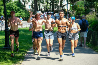 Kenny Moll (front, blue shorts) and Michael-Luca Natt (front, black shorts) finish their sixth marathon in the same amount of days to raise awareness for the impacts of climate change. Credit: Keerti Gopal/Inside Climate News