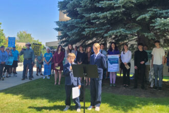 Nate King (aged 6) and Jeff King (aged 10), the youngest plaintiffs of the case, speak at a press conference held outside the Montana Supreme Court building in Helena on Wednesday. Credit: Najifa Farhat/Inside Climate News