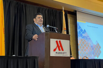 Mike Halona, executive director of the Navajo Nation Division of Natural Resources, talks about the purpose of the tribe’s energy summit on June 5 in Albuquerque. Credit: Noel Lyn Smith/Inside Climate News