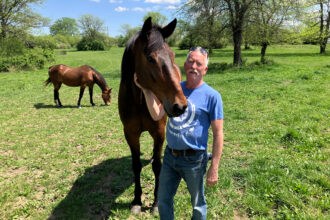 Mark Forrest, Madison County commissioner and owner of a horse boarding business, stands with one of his horses, Pepe. Forrest lost his bid for re-election in the Republican primary in part because of his support for the Oak Run solar project. Credit: Dan Gearino/Inside Climate News