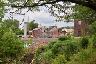 SOBE Energy Solutions' site for its proposed tire pyrolysis chemical plant that would make synthetic gas to burn and produce steam for heating and cooling some downtown Youngstown, Ohio, buildings. Marketed as a green solution to waste and energy problems, critics view it as a source of unwanted toxic air emissions and a fire or explosion risk next to a large jail, student housing and other buildings. Credit: James Bruggers/Inside Climate News