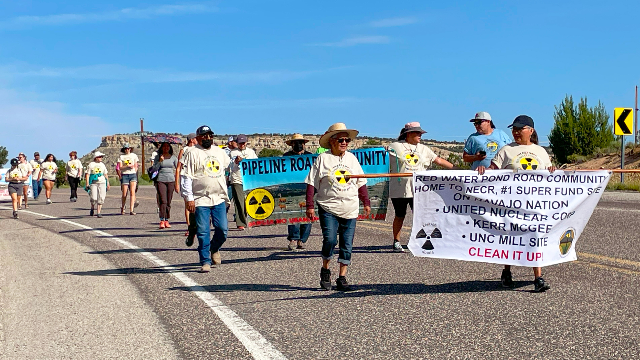 Residents and supporters walk southbound on New Mexico Highway 566 to the defunct uranium ore processing mill during the event on July 13 to remember the Church Rock uranium spill. Credit: Noel Lyn Smith/Inside Climate News