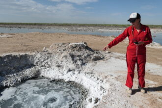 Oil and gas lawyer Sarah Stogner visits Lake Boehmer in Pecos County where abandoned wells have brought produced water to the surface for decades. The Railroad Commission considers these water wells and therefore not under their jurisdiction. Credit: Martha Pskowski/Inside Climate News