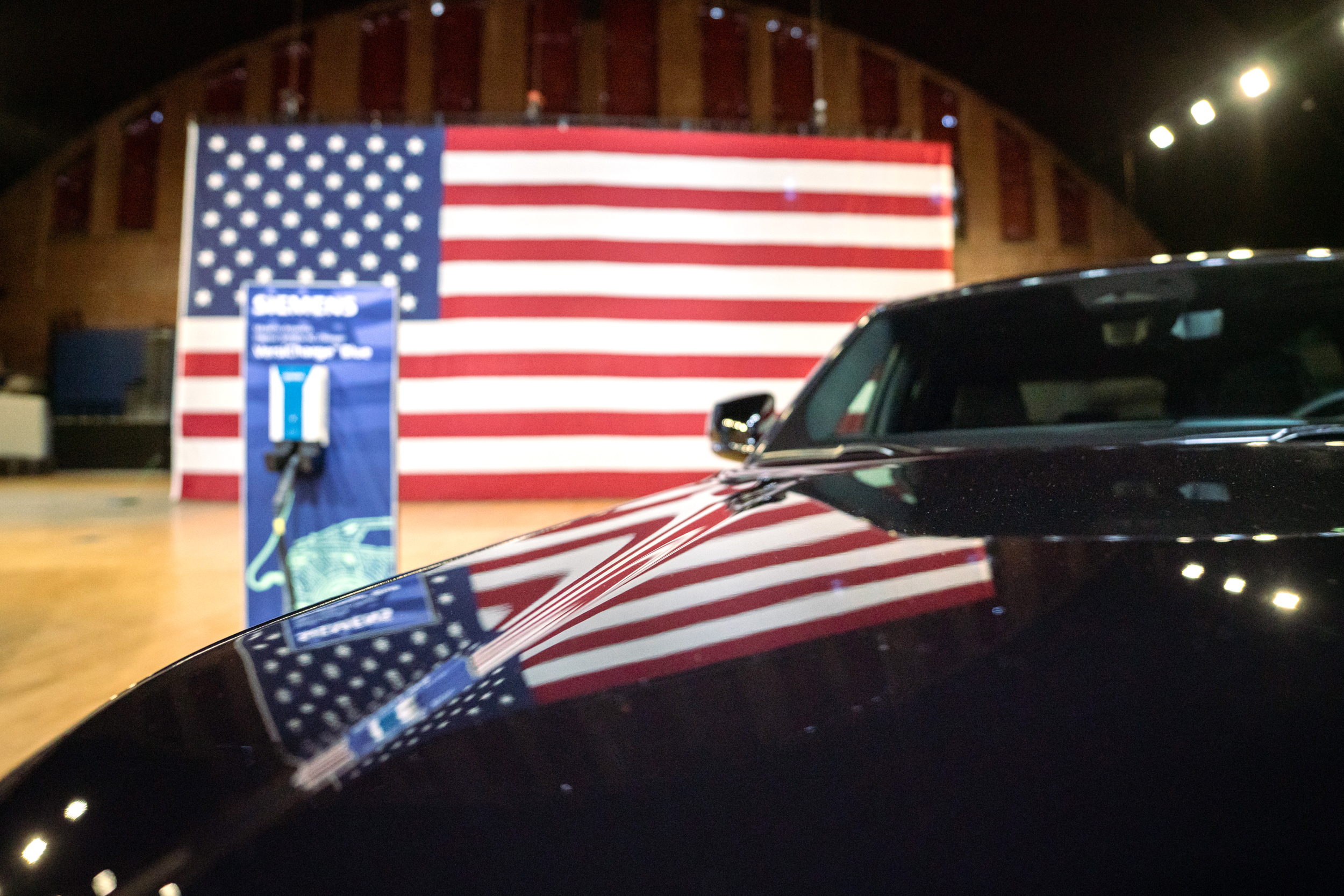 To highlight the cars that could help the U.S. lower transportation carbon emissions, the Biden administration showed off an array of iconic American vehicles, in varying shades of blue and with differing iterations of electric drive. Credit: EPA